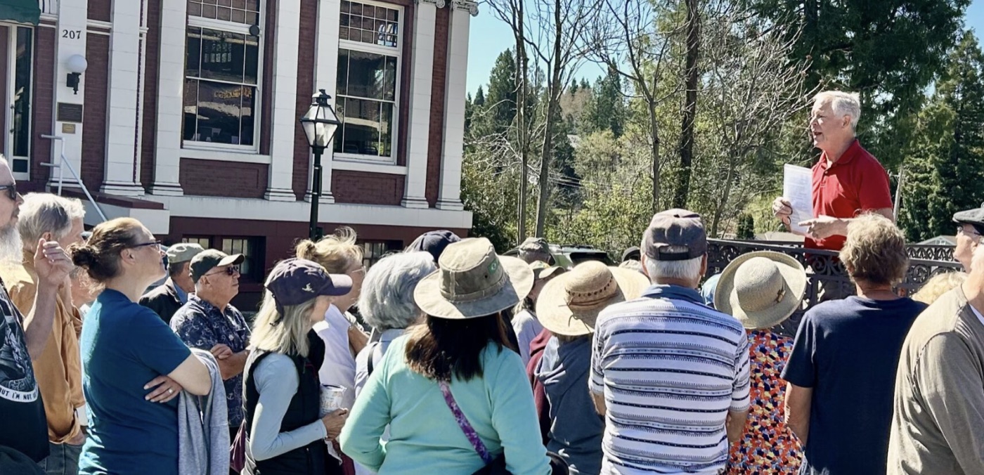 Terry McAteer leading a crowd on a historic walking tour of downtown Grass Valley